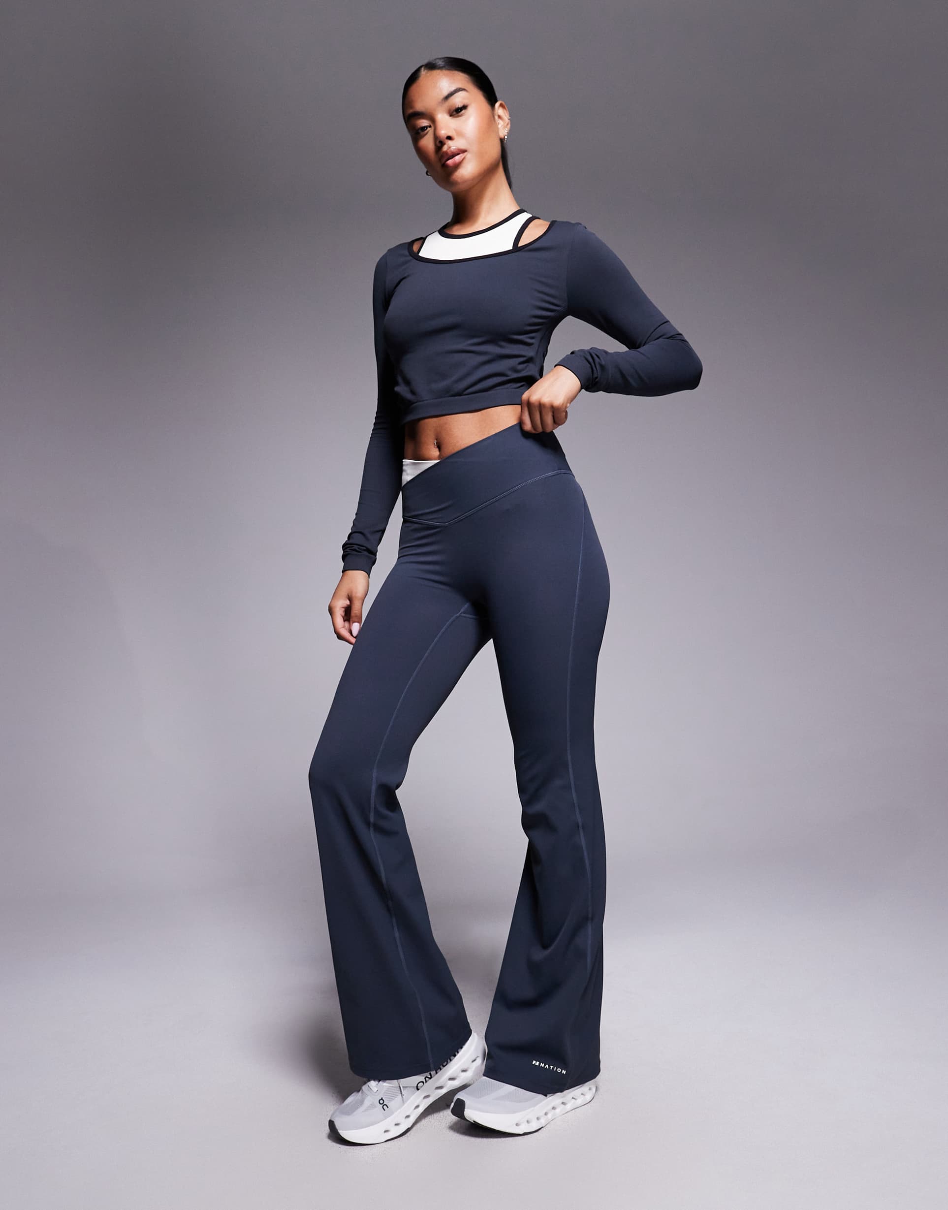 p.e nation wander flare leggings in marine blue and whisper white