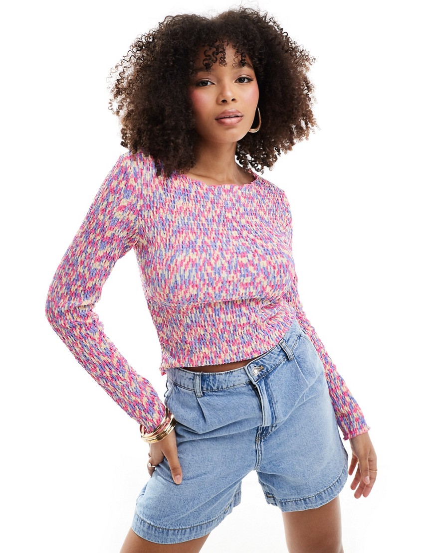 textured long sleeved top with pink lettuce edge stitching in multi print