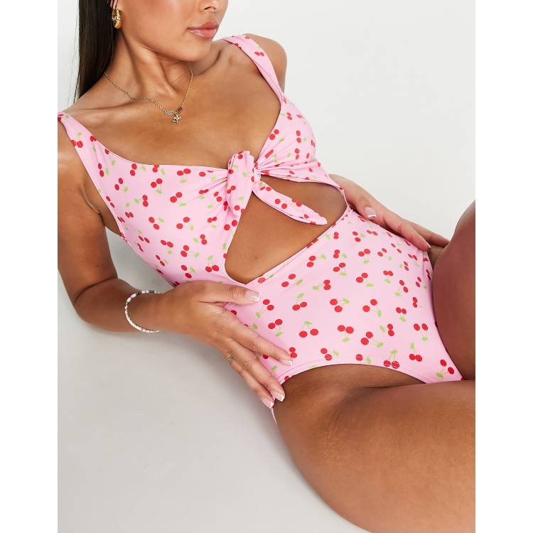 Pieces tie front cut out swimsuit in pink cherry print | ASOS