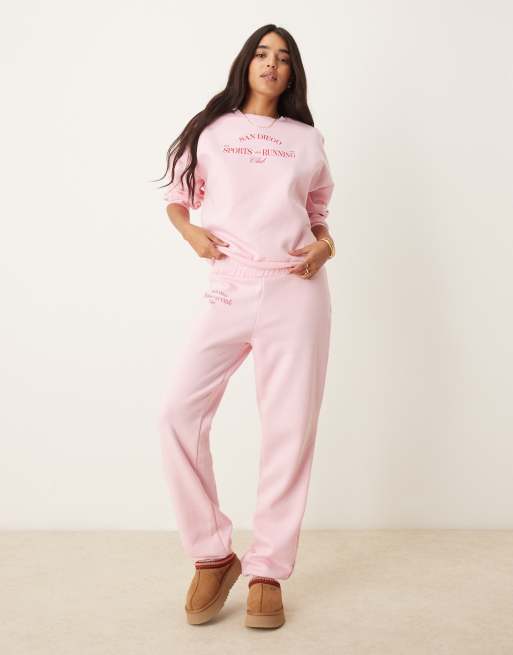 Pieces wellness 'sports & running club' cuffed sweatpants in baby pink - part of a set