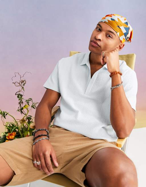Polo azul holgado con cuello de pico y acabado texturizado de ASOS DESIGN