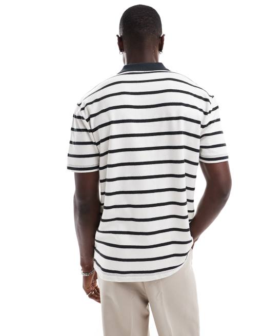 Polo blanco a rayas negras de corte holgado de ASOS DESIGN