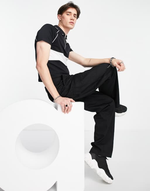 Polo negro de corte slim efecto encogido con media cremallera y panel en contraste de ASOS DESIGN , 4 de 4