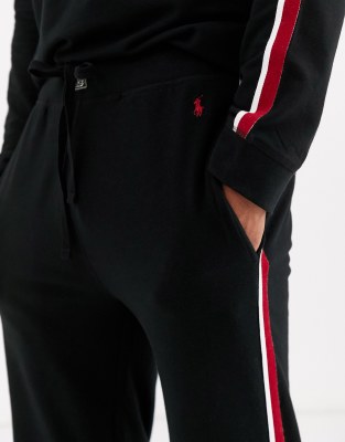 black joggers with red and white stripe