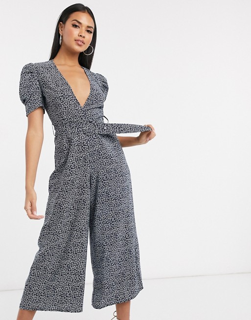 PrettyLittleThing belted jumpsuit with plunge neckline and puff sleeves in navy ditsy floral