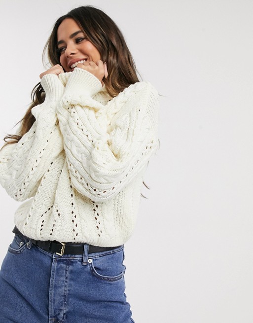 PrettyLittleThing roll neck jumper with cut out details in cream