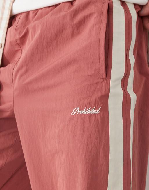 Prohibited stripe track pants in red
