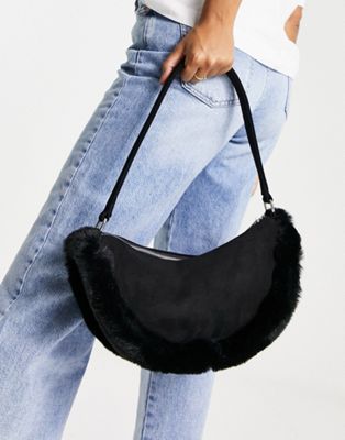 Public Desire The Kinley half moon bag in black with faux fur trim