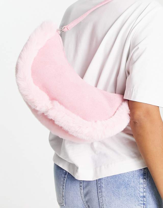 Public Desire The Kinley half moon bag in pink with faux fur trim