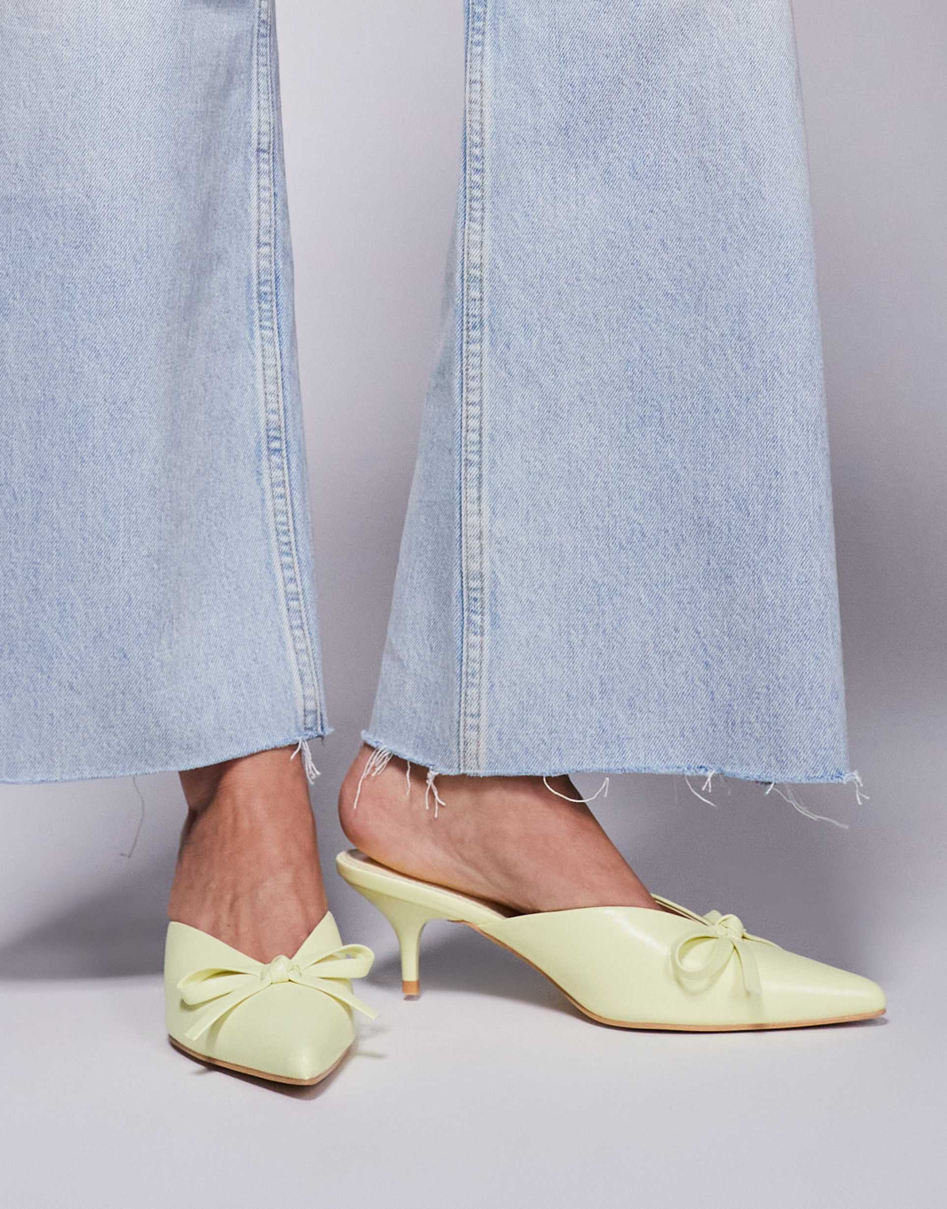 public desire wide fit lionheart pointed kitten heel mules with bow in yellow