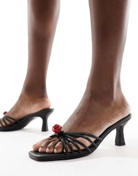 Public Desire Wide Fit Vertigo mid heeled mules with rosettes in black - view 1