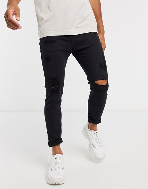 Pull&Bear carrot fit jeans in black with rips