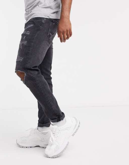 fit jeans with rips in black ASOS