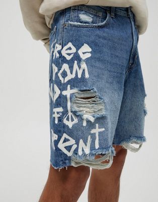 Pull&Bear graffiti denim shorts with rips in blue