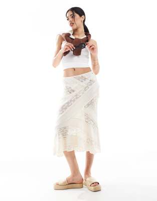 lace midi skirt with asymmetric hem in white