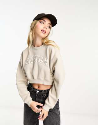 Pull & Bear 'Michigan' cropped varsity sweatshirt in sand-Neutral