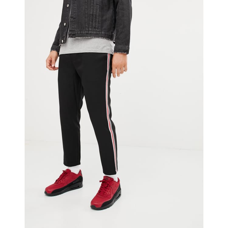 Black trousers with red and store white stripe