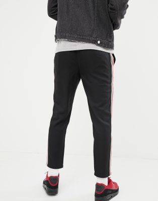 black trousers with red and white side stripe