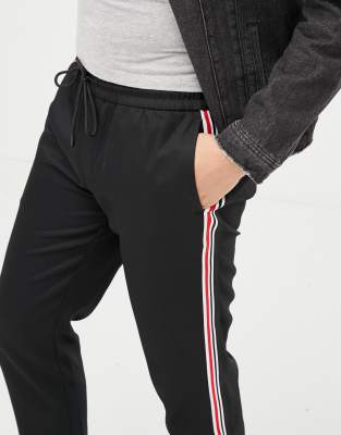black trousers with red and white side stripe