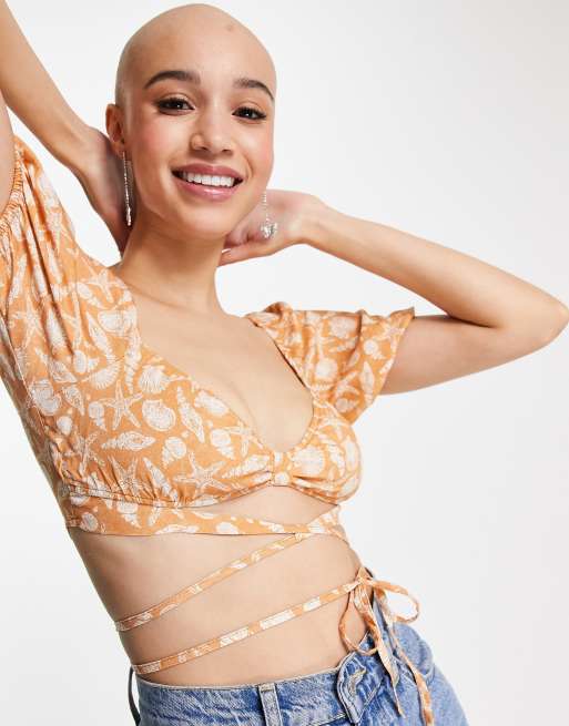 Pull&Bear wraparound cropped blouse in orange with star print