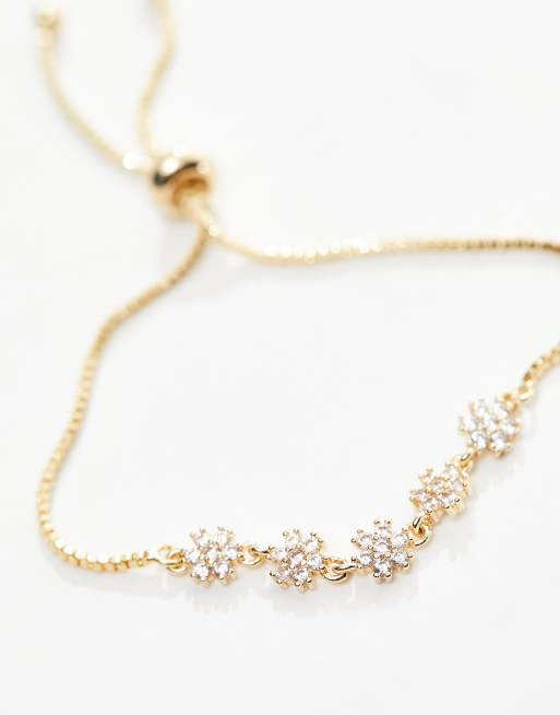 Pulsera de la amistad dorada con diseño de flores de circonitas con bolsa de regalo de ASOS DESIGN