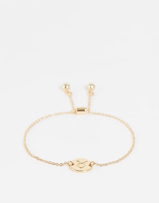 Pulsera dorada con charm del signo zodiacal Tauro de ASOS DESIGN