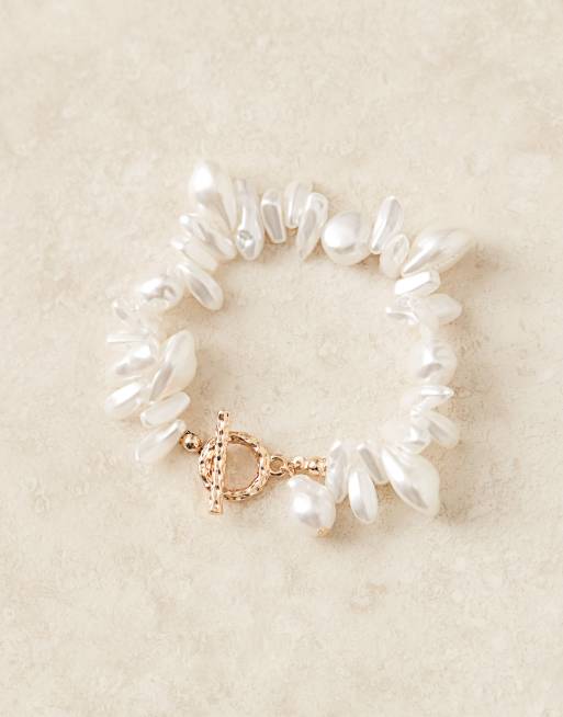 Pulsera dorada con detalle de barra en forma de T y perlas de imitación de ASOS DESIGN, 2 de 3
