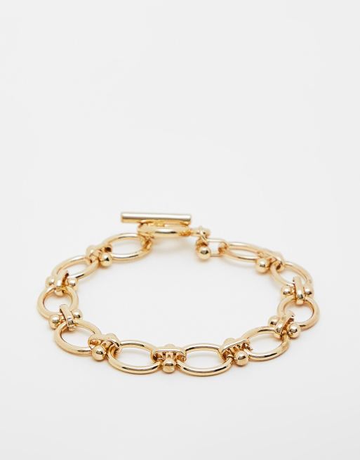 Pulsera dorada gruesa con cierre en forma de T de SVNX