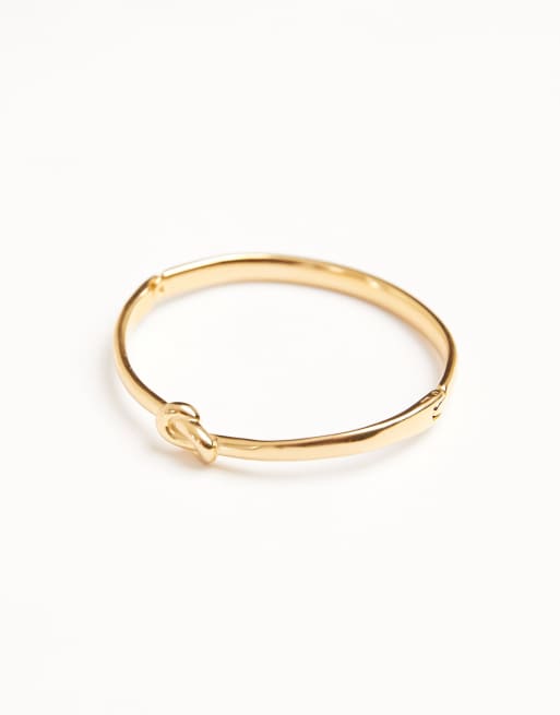 Pulsera rígida dorada con detalle de nudo de acero inoxidable resistente al agua de ASOS DESIGN, 2 de 3