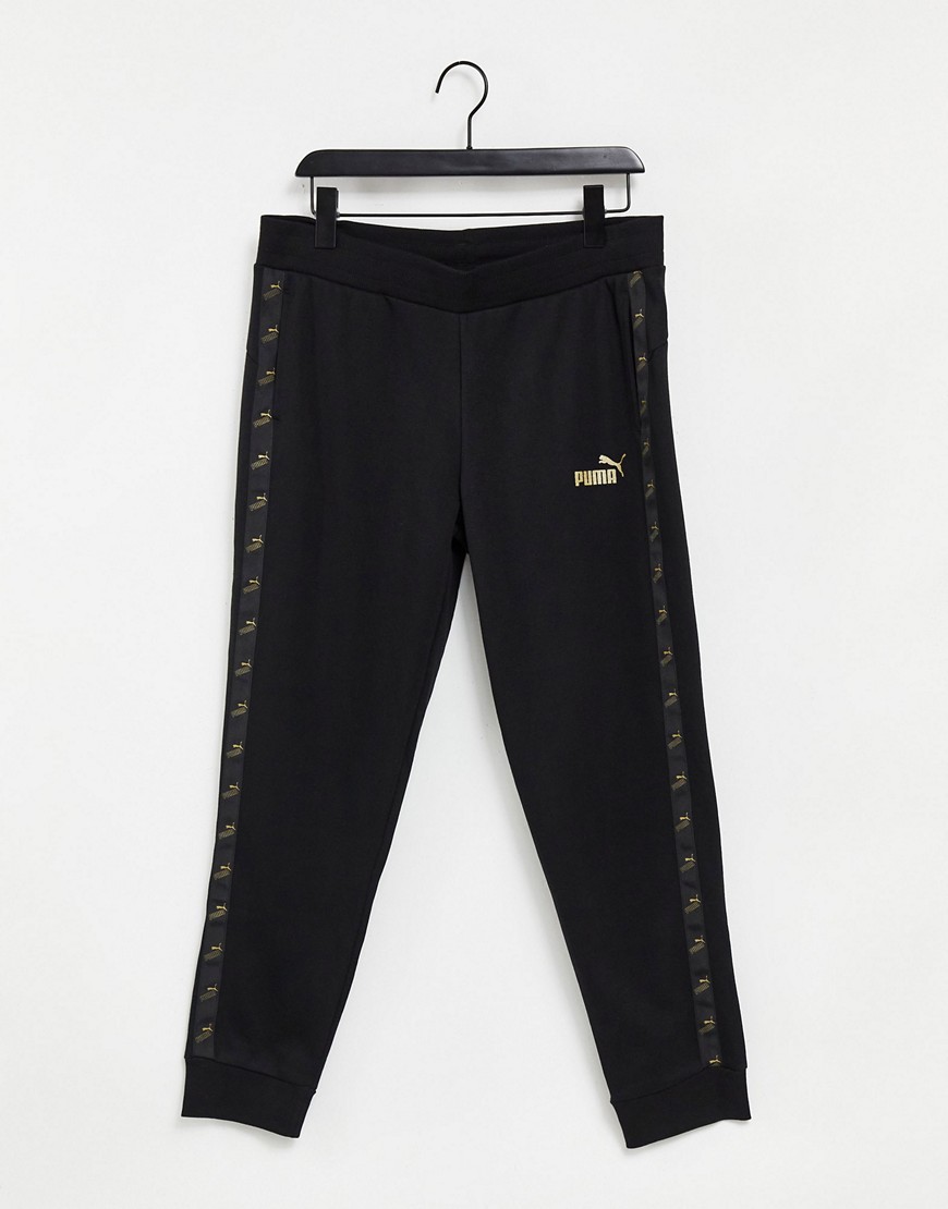 PUMA Amplified sweatpants in black and gold