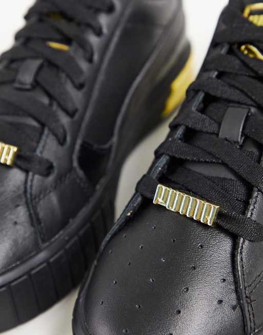 Puma Cali Star Metallic trainers in black and gold