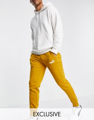 Puma Essentials joggers in ochre exclusive to ASOS