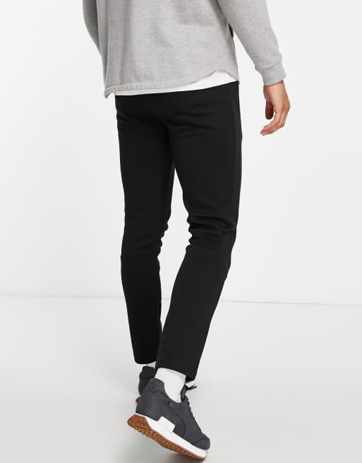 PUMA – Evostripe – Jogginghose in Schwarz mit goldfarbenem Raubkatzen-Logo, 2 von 4