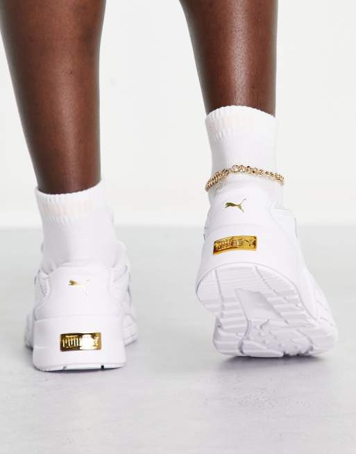 PUMA Hedra sneakers in white and gold