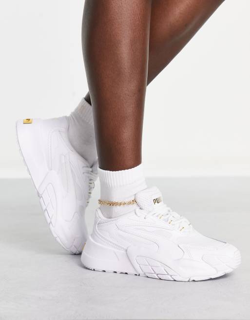 PUMA Hedra sneakers in white and gold