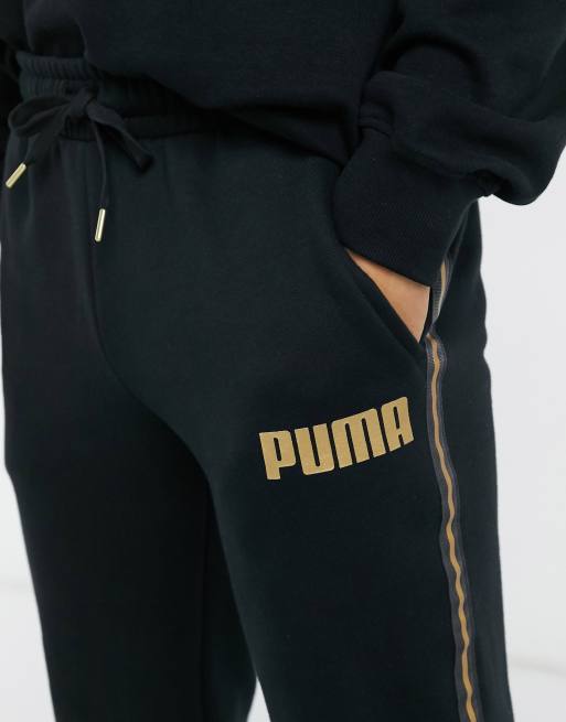 Puma joggers in black with gold taping