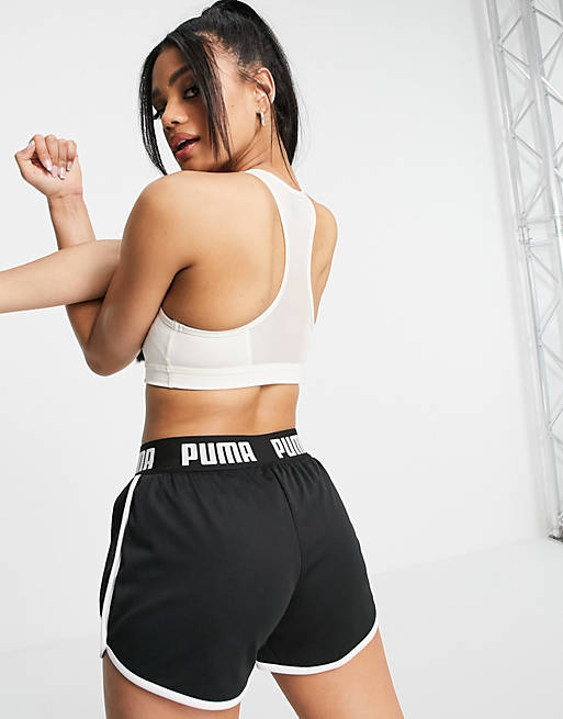 Women Puma mid support 4 Keeps sports bra with large cat logo in cream 