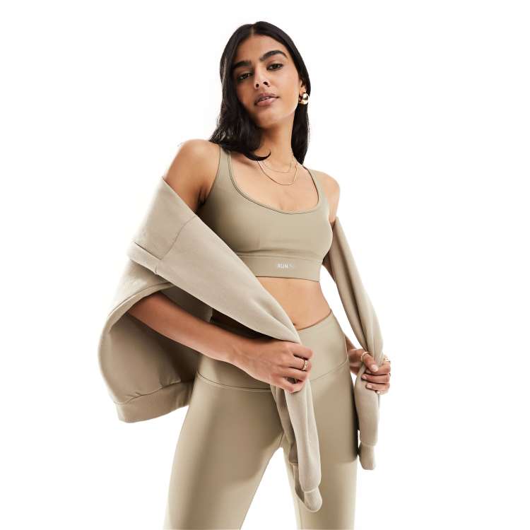 Puma Running Evolve medium support sports bra in brown | ASOS