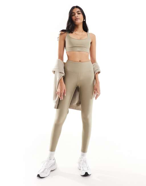 Puma Running Evolve medium support sports bra in brown | ASOS