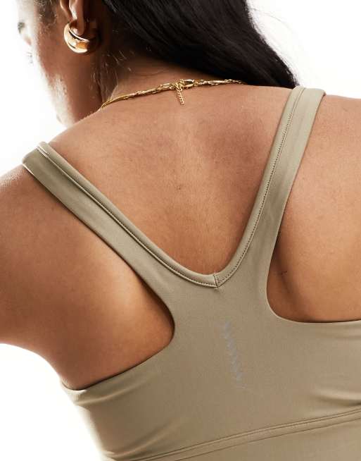 Puma Running Evolve medium support sports bra in brown | ASOS