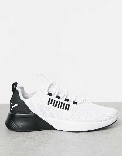 Puma black best sale and white trainers