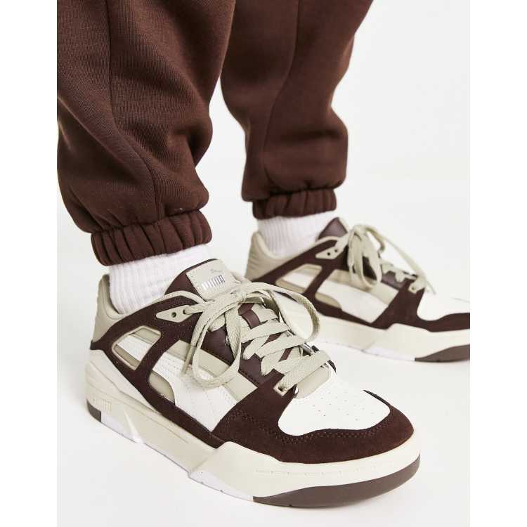 Brown and store white puma shoes