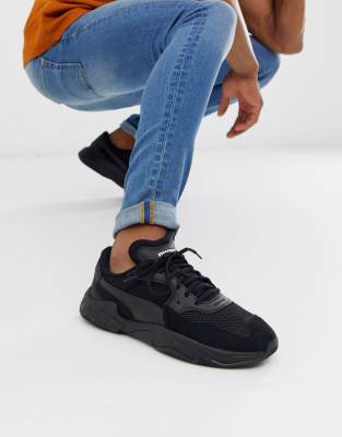 Puma Storm Origin trainers in black | ASOS