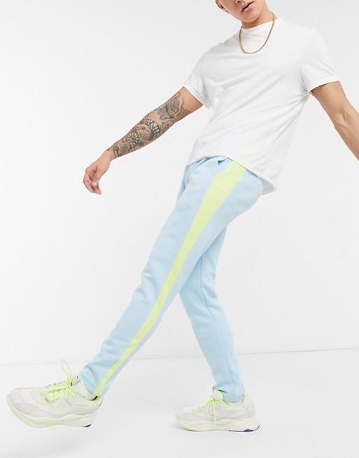 Puma summer luxe T7 trousers in blue with side stripe