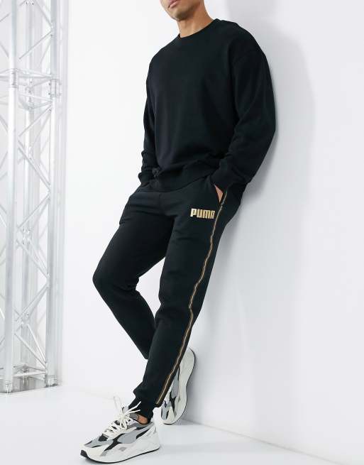 Puma sweatpants in black with gold taping