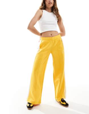 Puma Puma T7 low rise track trousers in yellow