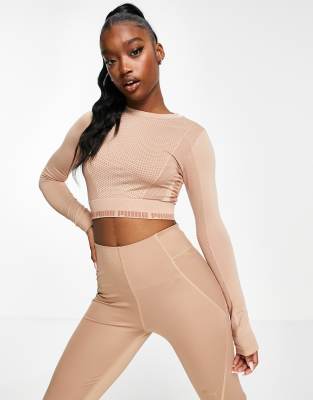 PUMA Training Evoknit seamless long-sleeved crop top in soft pink