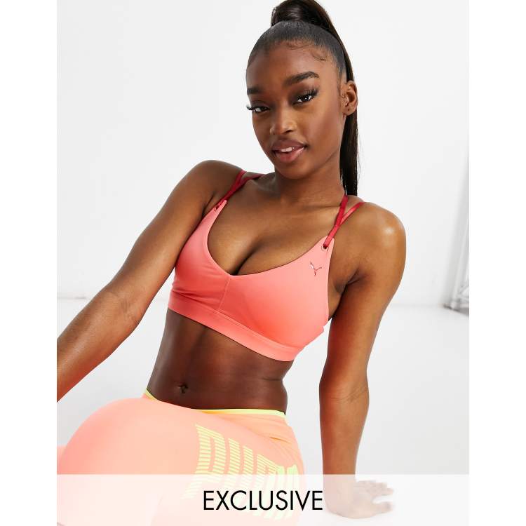 Puma Training sports bra in pink with red straps exclusive to ASOS