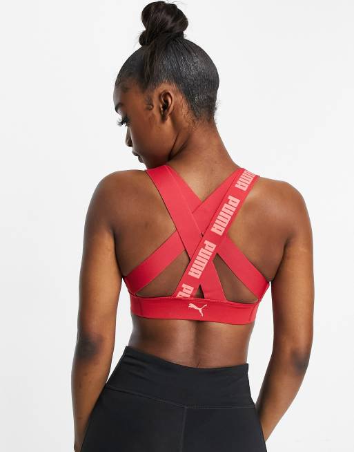 Puma Training sports bra in pink with red straps exclusive to ASOS