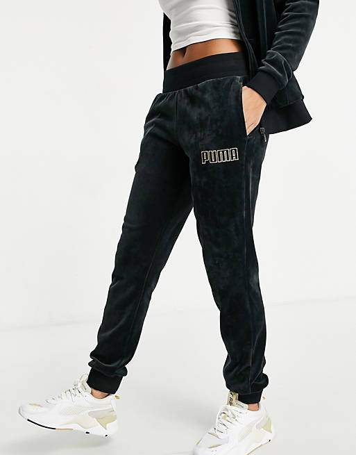 Puma velour sweatpants in black and gold